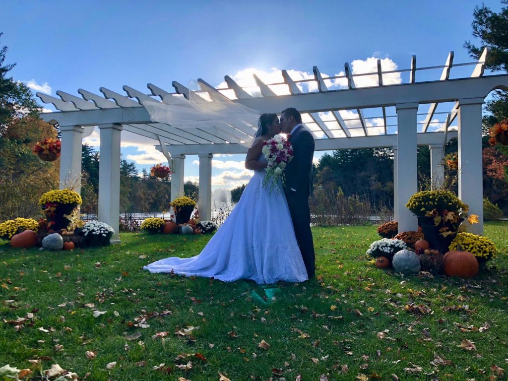 A bride and groom embrace on their wedding day at Butternut Farm Golf Club in Stow, Massachusetts